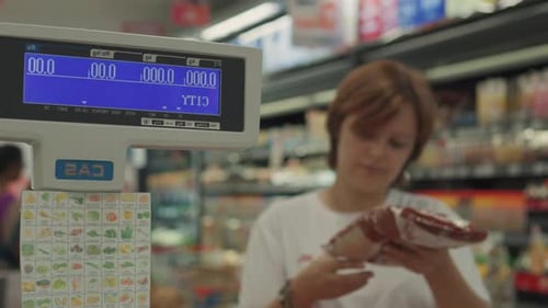 Young Woman Choosing Sugar in the Supermarket Close Up