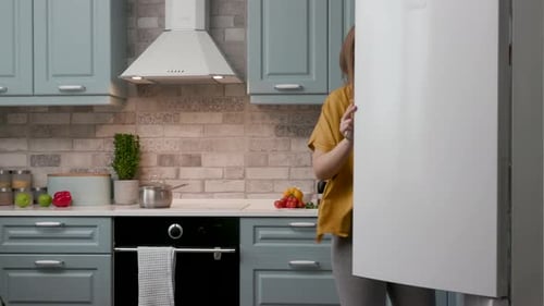 Pregnant Woman Dancing in Kitchen Cooking Food