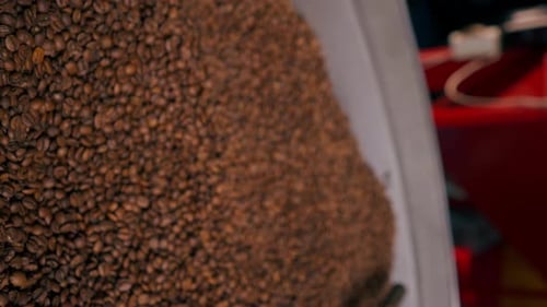 Vertical Video Closeup of a Coffee Roasting Factory Inside Drum Roasting Stirring Coffee
