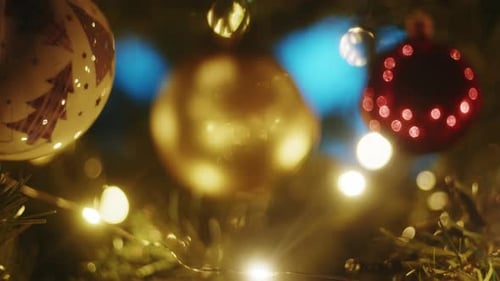 Gold Colored Christmas Bauble Shines on the Tree