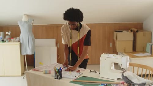 Male Tailor Working on Sewing-pattern in Atelier