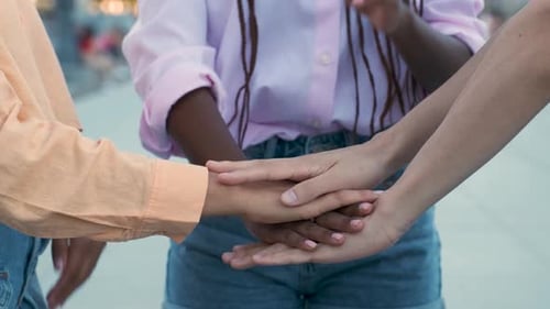 Close Up of Young Multiracial People Putting Their Hands Together