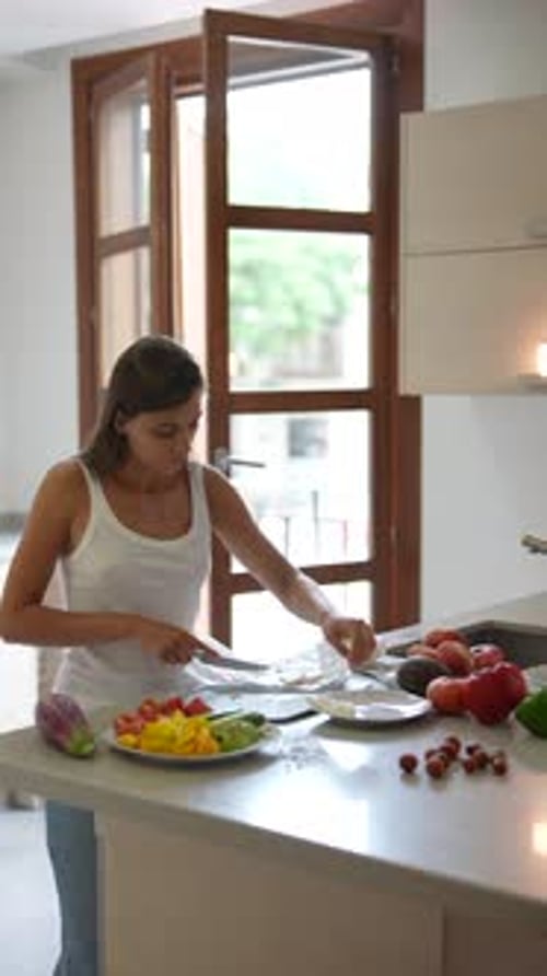 Young Woman Preparing Food in Bright Kitchen