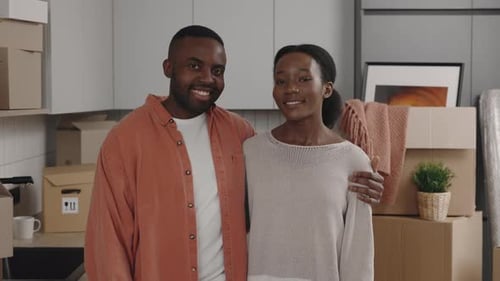 Happy Couple in New Home Surrounded by Boxes