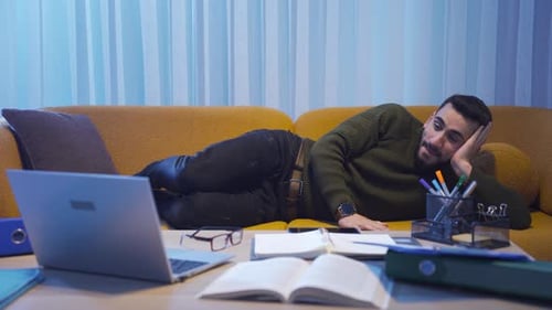 Man Laughing and Relaxing on a Couch