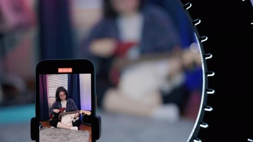 Young Adult Plays Guitar for Live Stream