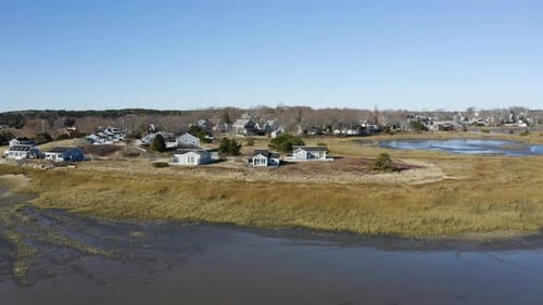 The camera highlights the Wellfleet Harbor Cottages that sit on the bluffs over looking the low tide