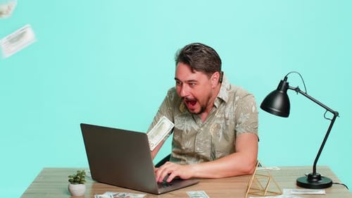 Man Working at Computer Receives Good News