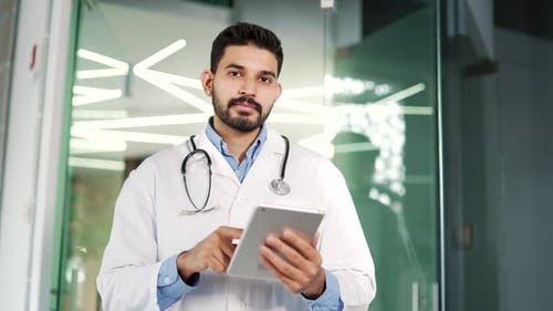 Professional Doctor Using Tablet in Hospital Setting