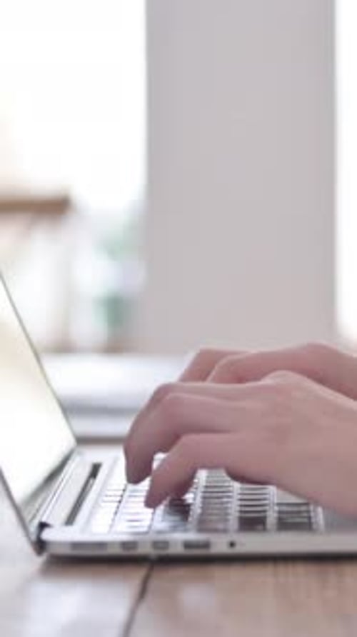 Close Up of Female Hands Typing on Laptop, Side View, Vertical Video