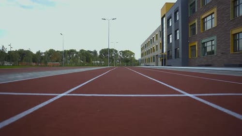Vibrant Red Running Track with Smooth Surface at Stadium