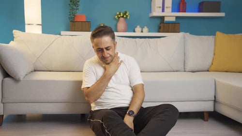 Sick man coughing leaning against wall. Hopeless.