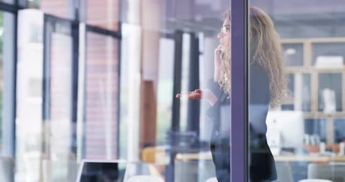 4k video footage of an attractive young businesswoman talking on a cellphone in an office