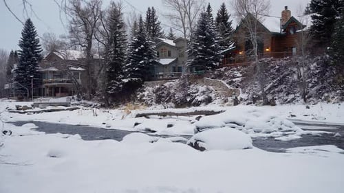 Idyllic Village and Snowy Landscape on Cold Winter Day, Creek and Conifer Trees