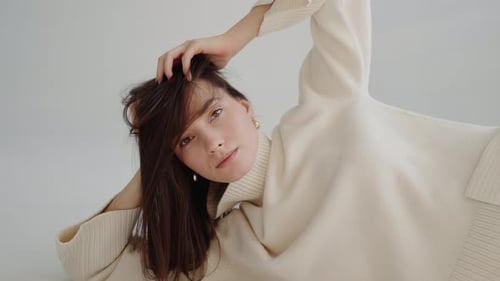 Stylish Woman Posing in Cream Sweater