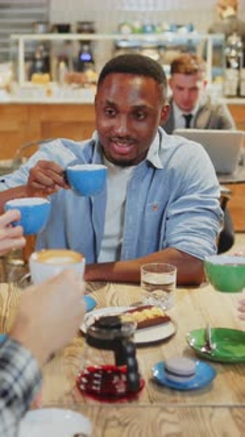 Casual Coffee Meeting with Friends in a Modern Caf Setting