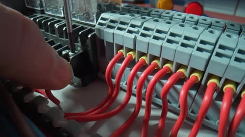 Electrician Connects Wires to Electrical Circuits