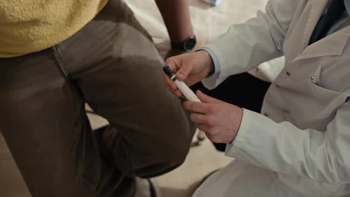 Doctor Explaining Insulin Pen to Diabetic Patient