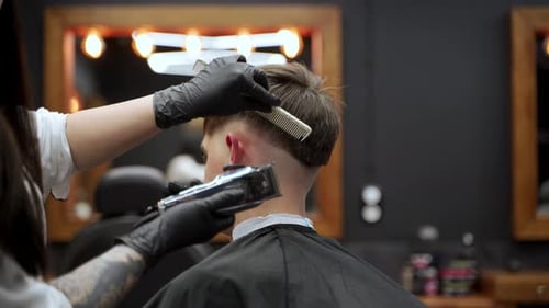 Hair Stylist Cuts Hair in a Modern Barber Shop