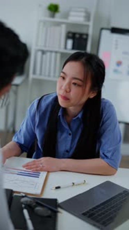 Woman Discussing Data and Shaking Hands in Office