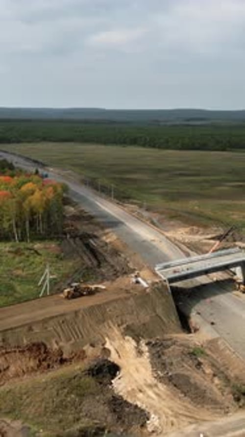 Bridge Construction Progress Over Rural Highway Clip