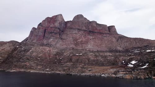 Majestic Rugged Mountain Peaks Under A Vast Dramatic Cloudy Sky
