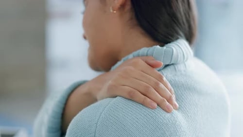Woman Massaging Shoulder, Close Up Indoor Shot