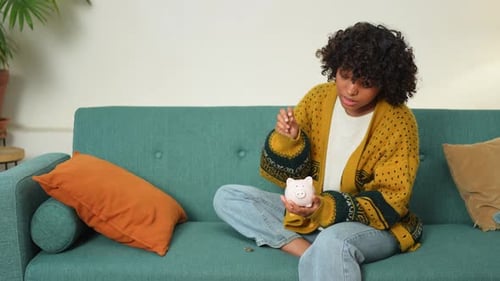 Saving Money Investment for Future African American Girl Holding Pink Piggy Bank and Putting Money