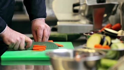 Chef Cuts Carrots in Commercial Kitchen