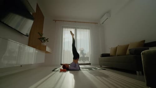 Woman Doing Yoga Pose in Bright Living Room