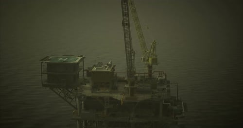Oil Rig Platform Rising Above Calm Waters During Overcast Weather
