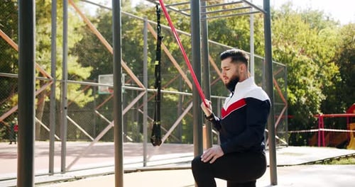 Trainer Male Correcting Fit Does Gym Exercises with Rubber Band