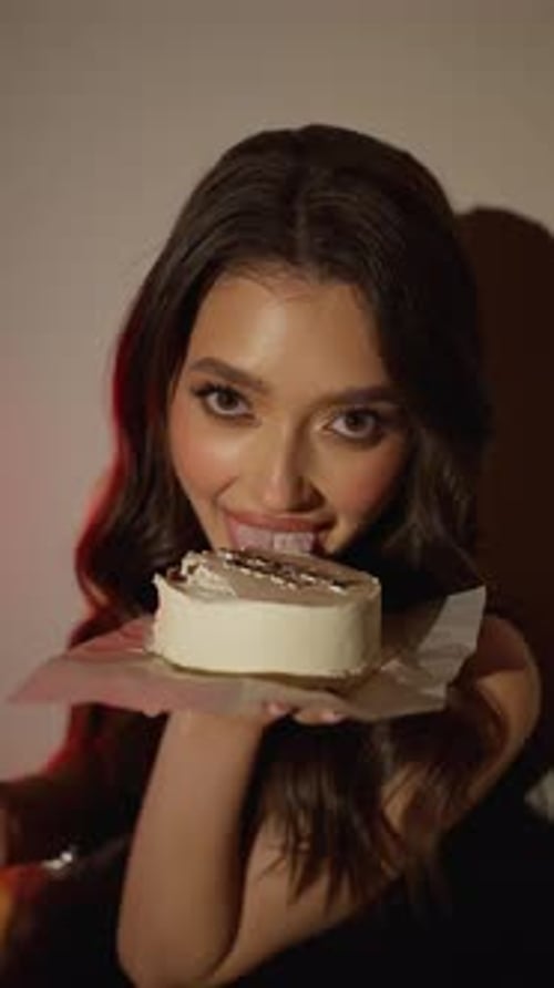 Beautiful Woman Looks at Cake Lovingly Close Up