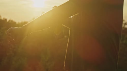 Man Sprays Mosquito Repellent at Sunset on Mountain