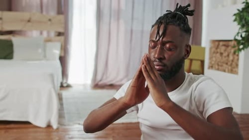 Man Meditating in Brightly Lit Room