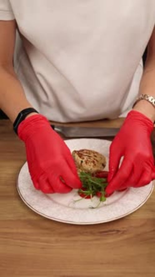 The chef prepares a dish of meat in the kitchen. Close-up