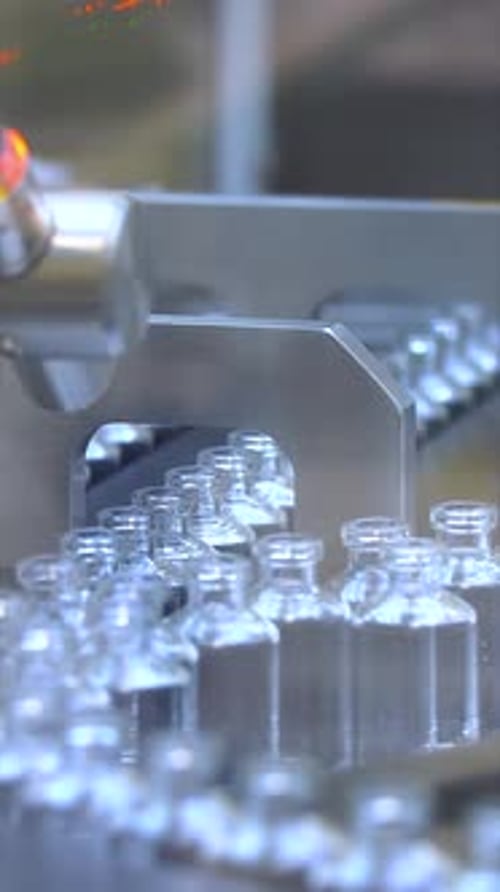 Automated Pharmaceutical Production: Glass Vials on Conveyor Belt