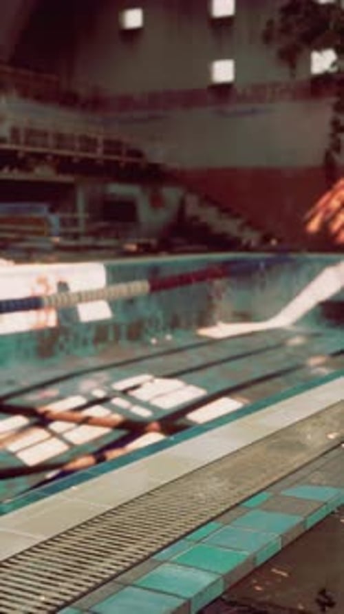 Abandoned Swimming Pool With Central Bench