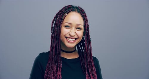 Woman Smiling and Making a Heart Shape with Hands
