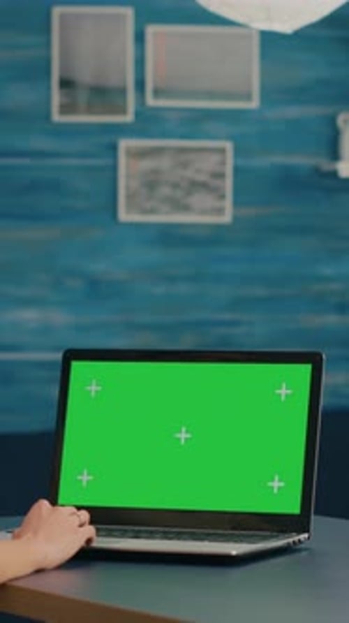Vertical Video Freelancer Using Computer with Mock Up Green Screen Chroma Key