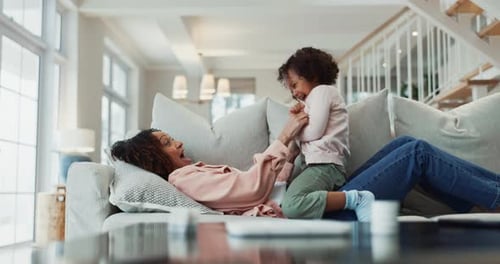Mother and Child Playing Together on Couch
