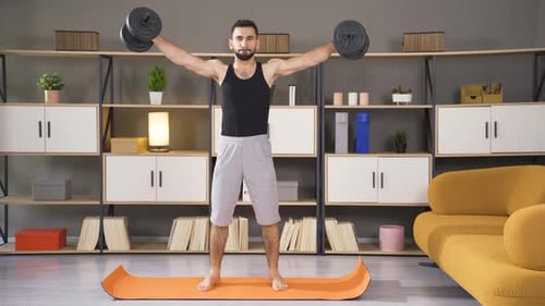 Man Doing Dumbbell Workout At Home