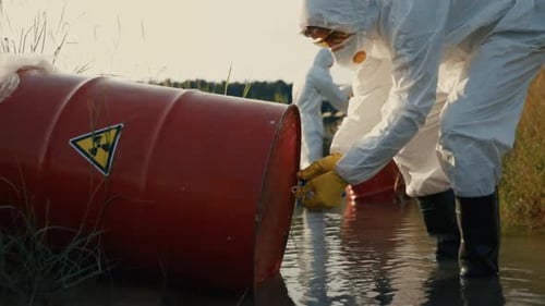 Workers in Hazmat Suits Collect Samples in Marsh