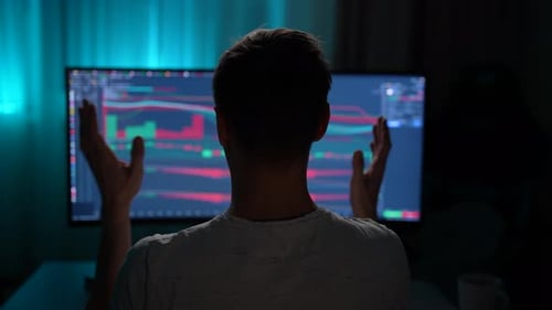 Back View of Worried Young Trader Man Disappointed for Failed Strategy of Trading While Watching