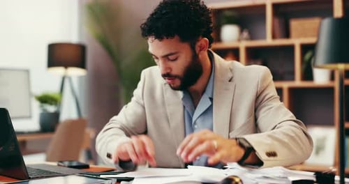 Young Adult Works with Documents at Office Desk