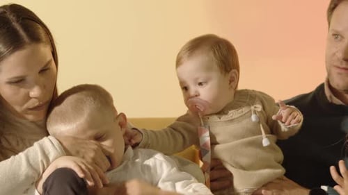 Loving Family Sitting Closely Together Indoors