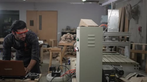 Carpenter is working at workshop.