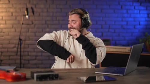 Man Enjoying New Song in Headphones at Recording Studio