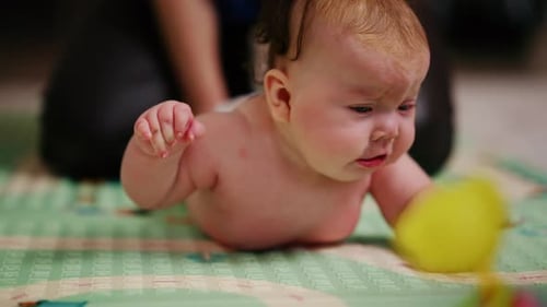 Adorable Infant Lying on Stomach with Toy