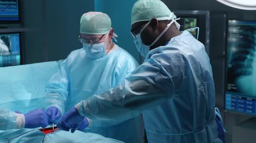 Team of Professional Medical Surgeons Performs the Surgical Operation in a Modern Hospital Doctors